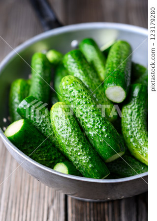 Metal colander with fresh cucumbers Metal colander with fresh cucumbers 123179280