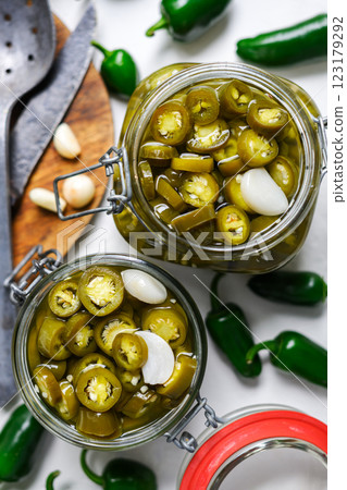 Spicy Mexican jalapeno peppers pickled and stored in mason jars 123179292