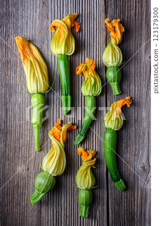 Young fresh zucchini with flowers on rustic wooden table 123179300