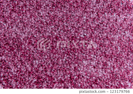 Close up of pink homemade knitted fabric with large stitches. Textured background 123179766