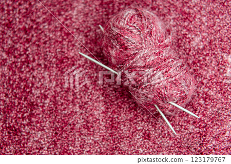 Close up of pink homemade knitted fabric with large stitches. Textured background 123179767