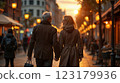 Happy European senior couple in love walking together in city streets on sunny summer evening 123179936