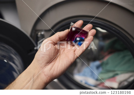 Using Laundry Detergent Pods While Doing Laundry in the Washing Machine with Clothes Using Laundry Detergent Pods While Doing Laundry in the Washing Machine with Clothes 123180198
