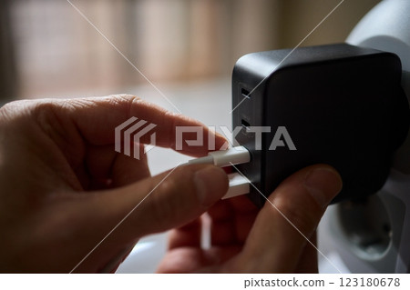 Charging devices that feature multiple ports and connectors for versatile connectivity 123180678