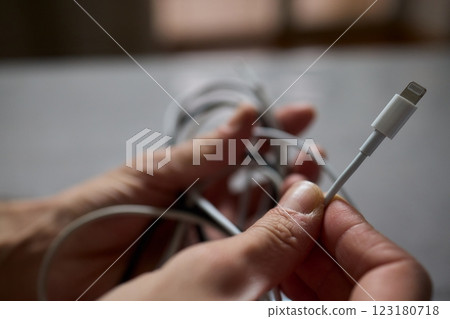 Tangled Cords in Hand The Everyday Clutter and Chaos of Our Modern Technology Life Tangled Cords in Hand The Everyday Clutter and Chaos of Our Modern Technology Life 123180718