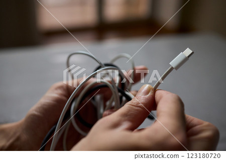 Tangled Cords in Hand The Everyday Clutter and Chaos of Our Modern Technology Life Tangled Cords in Hand The Everyday Clutter and Chaos of Our Modern Technology Life 123180720
