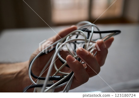 Tangled Cords in Hand The Everyday Clutter and Chaos of Our Modern Technology Life 123180724
