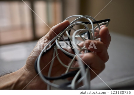 Tangled Cords in Hand The Everyday Clutter and Chaos of Our Modern Technology Life Tangled Cords in Hand The Everyday Clutter and Chaos of Our Modern Technology Life 123180726