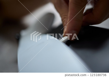 Charging a Device by Using a Hand to Insert a Cable to Connect It and Power It Up 123180736