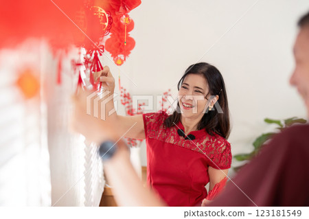 Elderly couple celebrating chinese new year in their home joyful decorations warm atmosphere 123181549