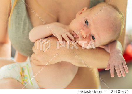A mother lovingly embraces her newborn baby, holding them close to her chest. A tender moment of warmth, security, and deep maternal love, symbolizing bonding, comfort, and the unbreakable connection A mother lovingly embraces her newborn baby, holding them close to her chest. A tender moment of warmth, security, and deep maternal love, symbolizing bonding, comfort, and the unbreakable connection 123181675