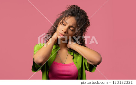 Bored african teen girl feeling pain neck joint,massaging muscles, rubbing head. Bored african teen girl feeling pain neck joint,massaging muscles, rubbing head. 123182321