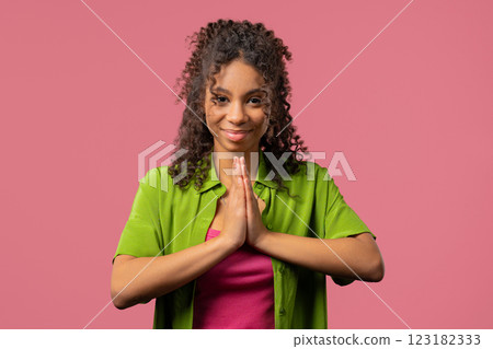 Believer Teen Girl Praying,Reads Prayer, Pink Background.hope, Wish, Gratitude Believer Teen Girl Praying,Reads Prayer, Pink Background.hope, Wish, Gratitude 123182333