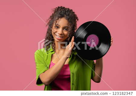 Young african teen or woman with vinyl record disc. Hobby,Music Lover,Collection 123182347