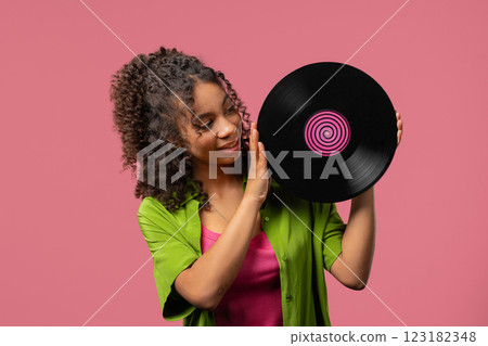 Young african teen or woman with vinyl record disc. Hobby,Music Lover,Collection 123182348