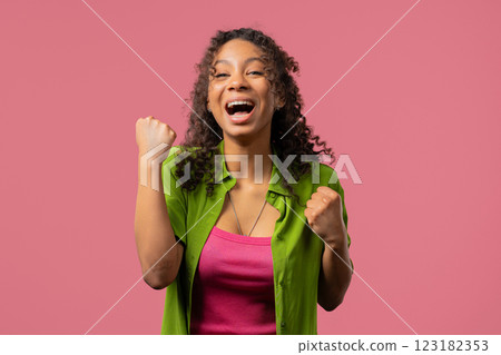 Young woman shows triumph yes gesture of victory. Glad teenager girl won, winner Young woman shows triumph yes gesture of victory. Glad teenager girl won, winner 123182353
