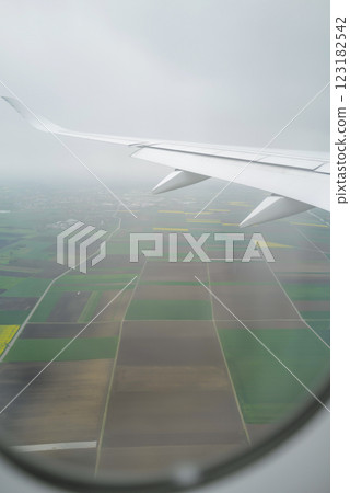 Airplane wing overlooking a rural landscape Airplane wing overlooking a rural landscape 123182542