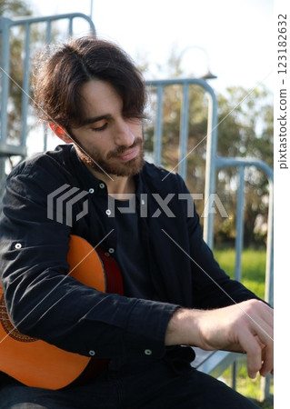 Man's Hand Passes Guitar Strings Preparatively Man's Hand Passes Guitar Strings Preparatively 123182632