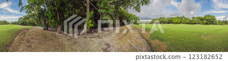 Scenic panorama of a tropical golf course surrounded by lush jungle. Serene landscape ideal for relaxation, sports, and luxury travel. Nature, recreation, and tropical getaway concept 123182652