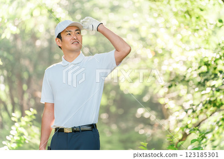 Male golfer wearing golf wear among fresh greenery (golf course, academy, membership) Male golfer wearing golf wear among fresh greenery (golf course, academy, membership) 123185301