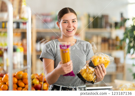 European youth girl choose and buy pasta in store European youth girl choose and buy pasta in store 123187136