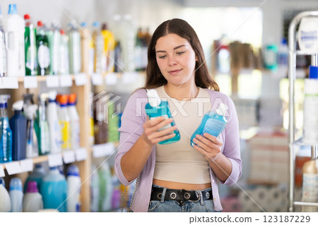Young woman choosing mouthwash in store 123187229