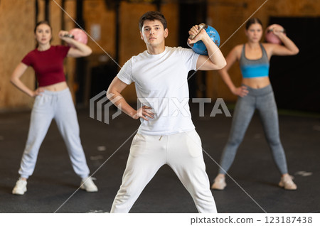 Man exercising with a kettlebell 123187438