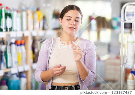 Young woman choosing cosmetics in department store Young woman choosing cosmetics in department store 123187487
