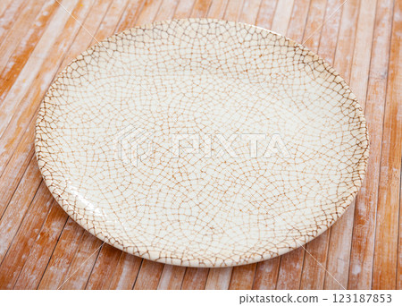 White plate on wooden table White plate on wooden table 123187853