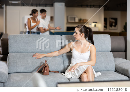 Portrait of woman consumer choosing sofa in furniture shop Portrait of woman consumer choosing sofa in furniture shop 123188048