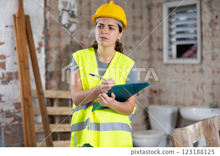 Female architect checking project documentation 123188125