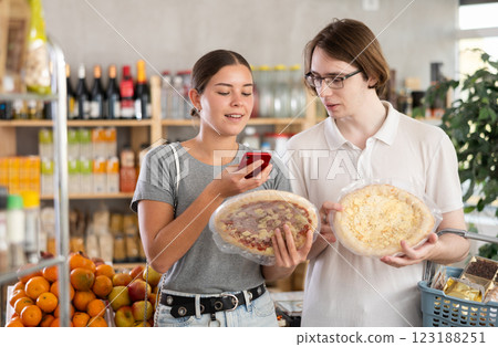 Couple man and woman scanning qr code for pizza Couple man and woman scanning qr code for pizza 123188251