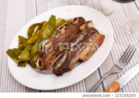 Churrasco de ternera, delicious grilled veal ribs with side of beans Churrasco de ternera, delicious grilled veal ribs with side of beans 123188293