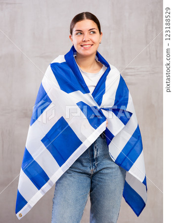 Smiling young woman holding Greece flag 123188529