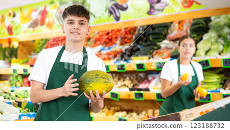 Portrait of a guy seller with melons in his hands 123188732