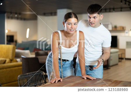 Happy couple who is satisfied of new furniture in store Happy couple who is satisfied of new furniture in store 123188980