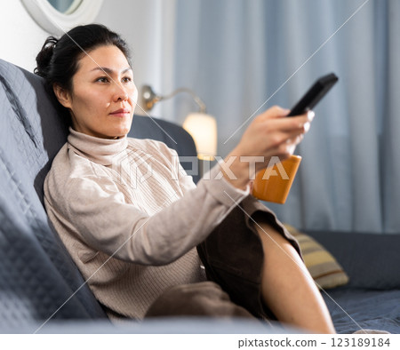 Asian woman watching TV 123189184