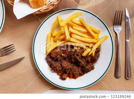 Wild boar in sauce with french fries Wild boar in sauce with french fries 123189246