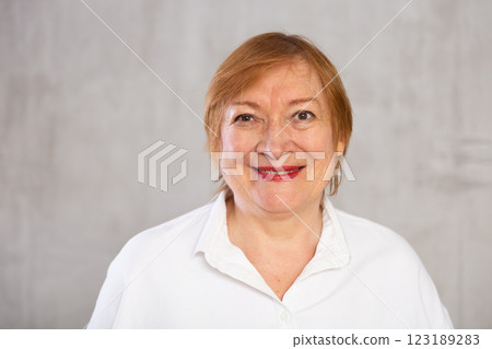 Older woman standing proudly with happy confident grin 123189283