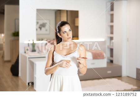 Adult woman looking around in bedroom department 123189752
