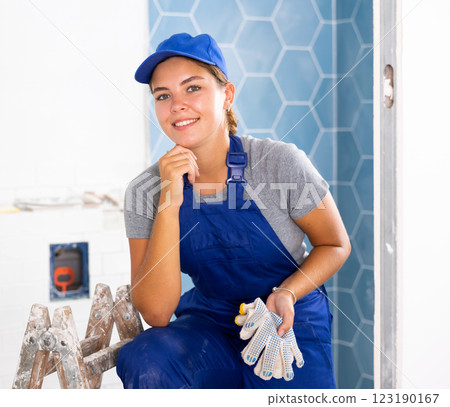 Portrait of a young woman tiler in the bathroom 123190167