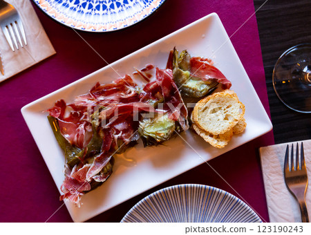 Fried artichokes with ham served on platter Fried artichokes with ham served on platter 123190243