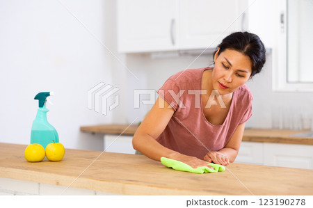 Woman householder using rag to wash table 123190278