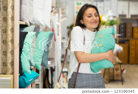 Latino american woman choosing pillow in textile shop 123190345