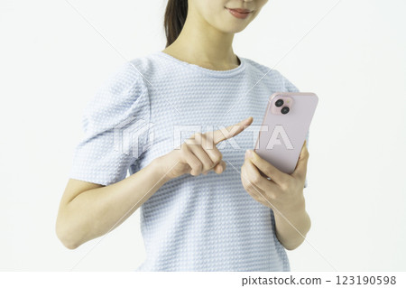 Close-up of a young woman's hand operating a smartphone 123190598
