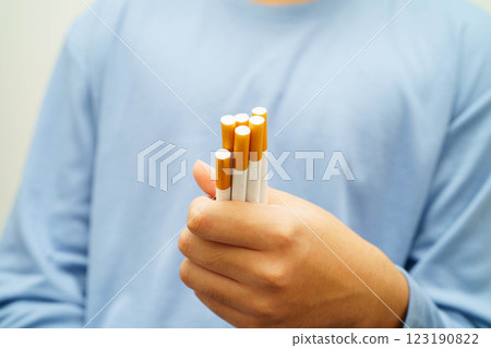Asian man holding cigarette, no smoking. Asian man holding cigarette, no smoking. 123190822