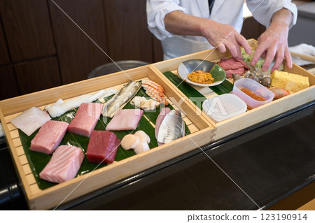 Sushi chef preparing the sushi toppings Sushi chef preparing the sushi toppings 123190914