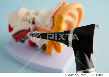 Otoscope with ear model for otolaryngologist or ENT physician doctor examining senior patient ear, hearing loss problem. 123190918