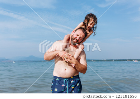 Dad and Daughter Having Fun at the Beach Dad and Daughter Having Fun at the Beach 123191656