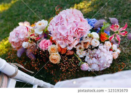 A beautiful bunch of colorful flowers sitting on the ground A beautiful bunch of colorful flowers sitting on the ground 123191670
